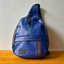An upcycled blue crossbody bag with brown details from pineapple-fiber leather.
