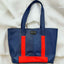 Eco-friendly blue upcycled tote bag with red details from pineapple fiber leather.