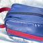 A close up photo of a blue and red toiletry bag